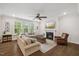 Bright living room with hardwood floors, a fireplace, and large windows overlooking the backyard at 2009 Latham Oaks Ave, Wake Forest, NC 27587