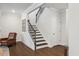 Bright foyer boasts a staircase with wood treads, iron railings, and natural light at 2009 Latham Oaks Ave, Wake Forest, NC 27587
