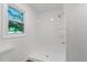 A bright and tidy bathroom featuring a window, stand-up shower with a hand-held shower head at 2085 Enon Rd, Oxford, NC 27565