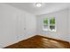 Bright bedroom with hardwood floors and large windows offering scenic outdoor views at 2085 Enon Rd, Oxford, NC 27565