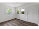 A bedroom with three windows allowing for ample natural light and a door leading to a closet at 2085 Enon Rd, Oxford, NC 27565