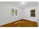 Sunlit bedroom with hardwood floors, a window with a view, and neutral walls at 2085 Enon Rd, Oxford, NC 27565