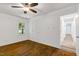 Bright bedroom features hardwood floors, a ceiling fan, and a window with a green outdoor view at 2085 Enon Rd, Oxford, NC 27565