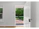 White front door entryway that provides great lighting and access to the landscaped front yard at 2085 Enon Rd, Oxford, NC 27565