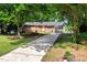 Charming brick ranch-style home with a concrete driveway and mature trees at 2085 Enon Rd, Oxford, NC 27565
