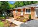 Well-maintained brick home with manicured landscaping and a cozy front porch at 2085 Enon Rd, Oxford, NC 27565