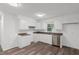 The updated kitchen offers sleek appliances and granite countertops and white cabinets at 2085 Enon Rd, Oxford, NC 27565