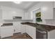 Updated kitchen with white cabinetry, stainless steel appliances, granite countertops, and a large window at 2085 Enon Rd, Oxford, NC 27565