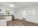 Bright kitchen features white cabinets, stainless steel dishwasher, granite countertops, and wood-look floors at 2085 Enon Rd, Oxford, NC 27565
