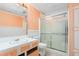 This is a bathroom featuring a vanity, toilet and a glass enclosed walk-in shower at 219 W Parker St, Graham, NC 27253