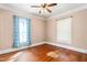 This is an empty bedroom with hardwood floors, and two windows with some natural light at 219 W Parker St, Graham, NC 27253