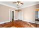 Bedroom featuring hardwood floors, closet space, and a neutral color palette, offering a blank canvas at 219 W Parker St, Graham, NC 27253