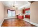 This is a dining room and kitchen combo featuring hardwood floors and view of kitchen with red cabinets at 219 W Parker St, Graham, NC 27253