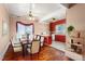 This is a dining room and kitchen in a staged photo showing a table with chairs and a kitchen island at 219 W Parker St, Graham, NC 27253
