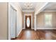 Open entryway with hardwood floors, chandelier, and natural light, creating a welcoming ambiance at 219 W Parker St, Graham, NC 27253