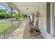 Spacious front porch with ample seating and charming decor, offering a welcoming outdoor living space at 219 W Parker St, Graham, NC 27253