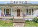 Inviting front porch with classic railings, seating, and a charming entryway leading to the home's entrance at 219 W Parker St, Graham, NC 27253