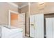 This is a laundry area that has a washer and dryer and vintage white side-by-side refrigerator and freezer at 219 W Parker St, Graham, NC 27253