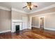 Bright living room with hardwood floors, fireplace, and an open layout to the next room at 219 W Parker St, Graham, NC 27253