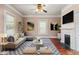 Staged living room featuring stylish furniture, fireplace, and ample natural light, creating a cozy atmosphere at 219 W Parker St, Graham, NC 27253