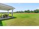 The backyard has a patio with furniture, providing outdoor seating and relaxation at 220 Rosewood Dr, Sanford, NC 27330