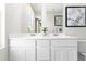 Elegant bathroom vanity with double sinks, sleek mirrors, and modern lighting fixtures at 220 Rosewood Dr, Sanford, NC 27330