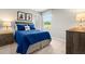 This bedroom showcases a inviting bed, decor and a window overlooking the outdoor scenery at 220 Rosewood Dr, Sanford, NC 27330