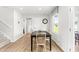 Bright dining room features wood floors, a black table with seating for six, and a large window at 220 Rosewood Dr, Sanford, NC 27330
