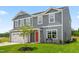 Beautiful two-story home with gray siding, a two-car garage, and a well-maintained front lawn at 220 Rosewood Dr, Sanford, NC 27330