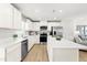 Spacious kitchen with white countertops, stainless steel appliances, a center island, and modern finishes at 220 Rosewood Dr, Sanford, NC 27330