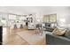 Bright living room with a sofa, decorative pillows, accent chair, and an open view to the kitchen at 220 Rosewood Dr, Sanford, NC 27330