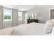 Well-lit main bedroom with large windows offering views, carpeted floors, and a dresser at 220 Rosewood Dr, Sanford, NC 27330