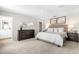 Bright main bedroom featuring carpeted floors, neutral walls, and a dark wood dresser at 220 Rosewood Dr, Sanford, NC 27330