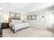 Carpeted main bedroom features neutral walls, stylish decor, and an ensuite bathroom at 220 Rosewood Dr, Sanford, NC 27330