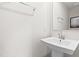 Modern powder room features a pedestal sink with chrome fixtures and a stylish mirror at 220 Rosewood Dr, Sanford, NC 27330