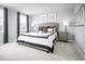 This bedroom is bright and airy with a large window and neutral gray walls at 221 Rosewood Dr, Sanford, NC 27330