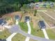 Overhead view of new homes in a growing community surrounded by lush trees and green spaces at 224 Wild Turkey Way, Lillington, NC 27546