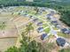 Expansive aerial view of a neighborhood showcasing well-maintained homes and landscaping near green spaces at 224 Wild Turkey Way, Lillington, NC 27546