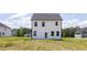 Rear exterior view of a white two-story home with ample backyard space at 224 Wild Turkey Way, Lillington, NC 27546