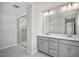 Bathroom with dual sinks, white countertops, gray cabinets, and a glass enclosed shower at 224 Wild Turkey Way, Lillington, NC 27546