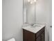 Bathroom featuring single sink vanity with white countertops and dark wood cabinets at 224 Wild Turkey Way, Lillington, NC 27546