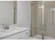Bathroom featuring a single sink vanity with white countertop and shower with glass doors at 224 Wild Turkey Way, Lillington, NC 27546