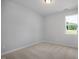 Minimalist bedroom design featuring neutral carpet and natural light from a window, creating a calm ambiance at 224 Wild Turkey Way, Lillington, NC 27546