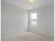 Bright bedroom with neutral carpet, fresh paint, and a window overlooking the front yard at 224 Wild Turkey Way, Lillington, NC 27546