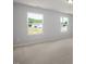 Bedroom featuring carpeted floor, and two windows that provides plenty of natural light at 224 Wild Turkey Way, Lillington, NC 27546