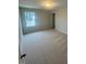 Bedroom featuring neutral carpet, natural light from a window, and a modern ceiling light at 224 Wild Turkey Way, Lillington, NC 27546