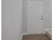 Entryway showcasing a white door and neutral-toned wall, offering a clean and welcoming feel at 224 Wild Turkey Way, Lillington, NC 27546