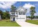 Charming two-story home featuring a white exterior, black shutters and a well-manicured front lawn at 224 Wild Turkey Way, Lillington, NC 27546