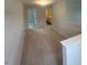 Hallway featuring neutral carpet and access to a bathroom and other rooms at 224 Wild Turkey Way, Lillington, NC 27546