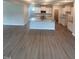 Open concept living area with a kitchen island featuring granite countertops and modern appliances at 224 Wild Turkey Way, Lillington, NC 27546